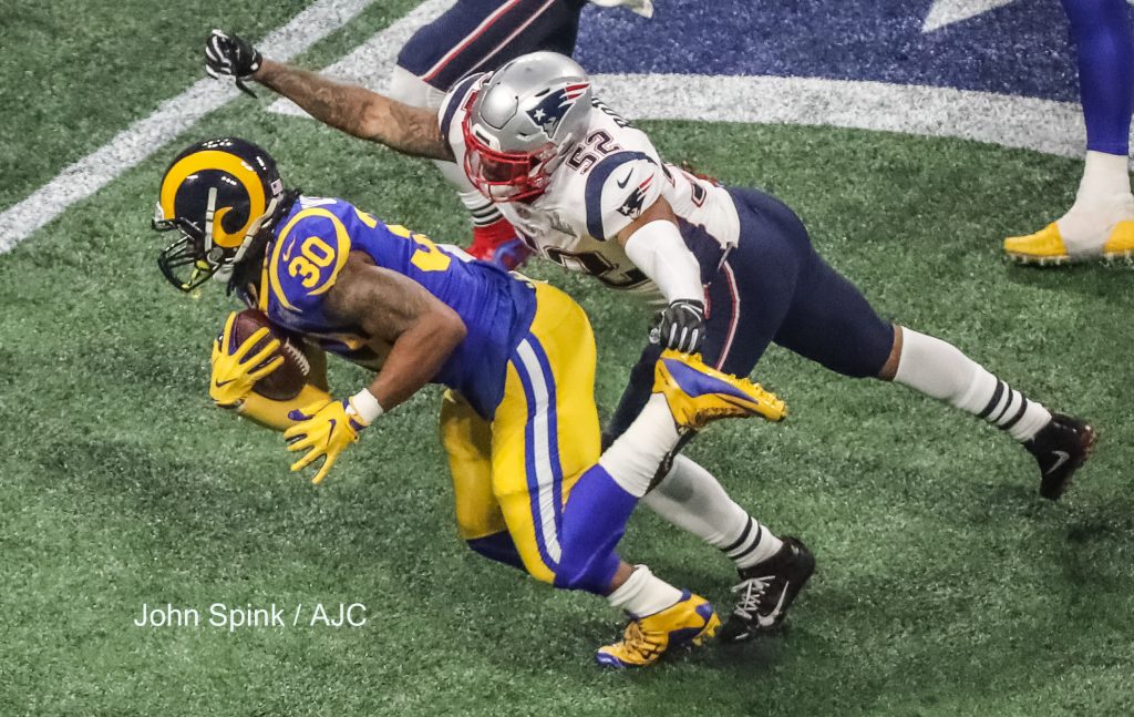 John Spink/Atlanta Journal-Constitution - Los Angeles Rams running back Todd Gurley (30) runs from the clutches of New England Patriots outside linebacker Elandon Roberts (52)(right) during 4th quarter play.