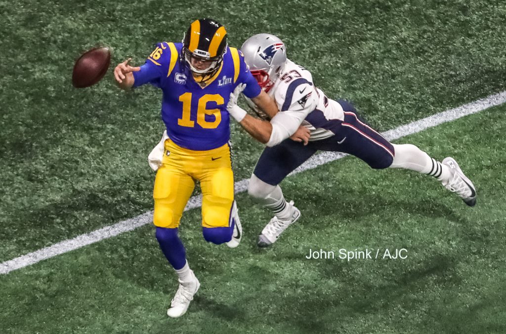 John Spink/Atlanta Journal-Constitution - Los Angeles Rams quarterback Jared Goff (16) throws the ball away after pressure from New England Patriots middle linebacker Kyle Van Noy (53). 