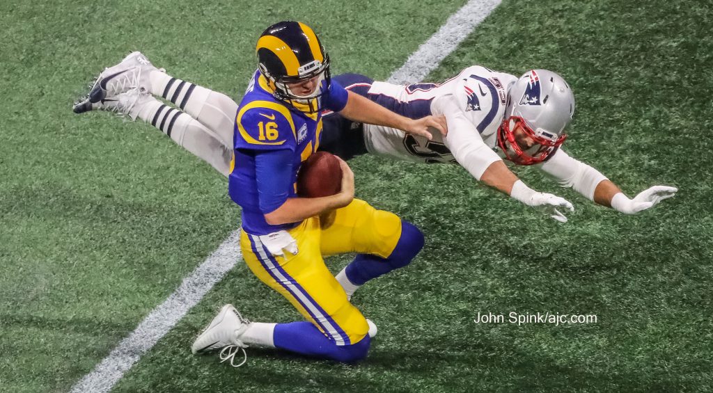 John Spink/Atlanta Journal-Constitution - Los Angeles Rams quarterback Jared Goff (16) throws the ball away after pressure from New England Patriots middle linebacker Kyle Van Noy (53). 